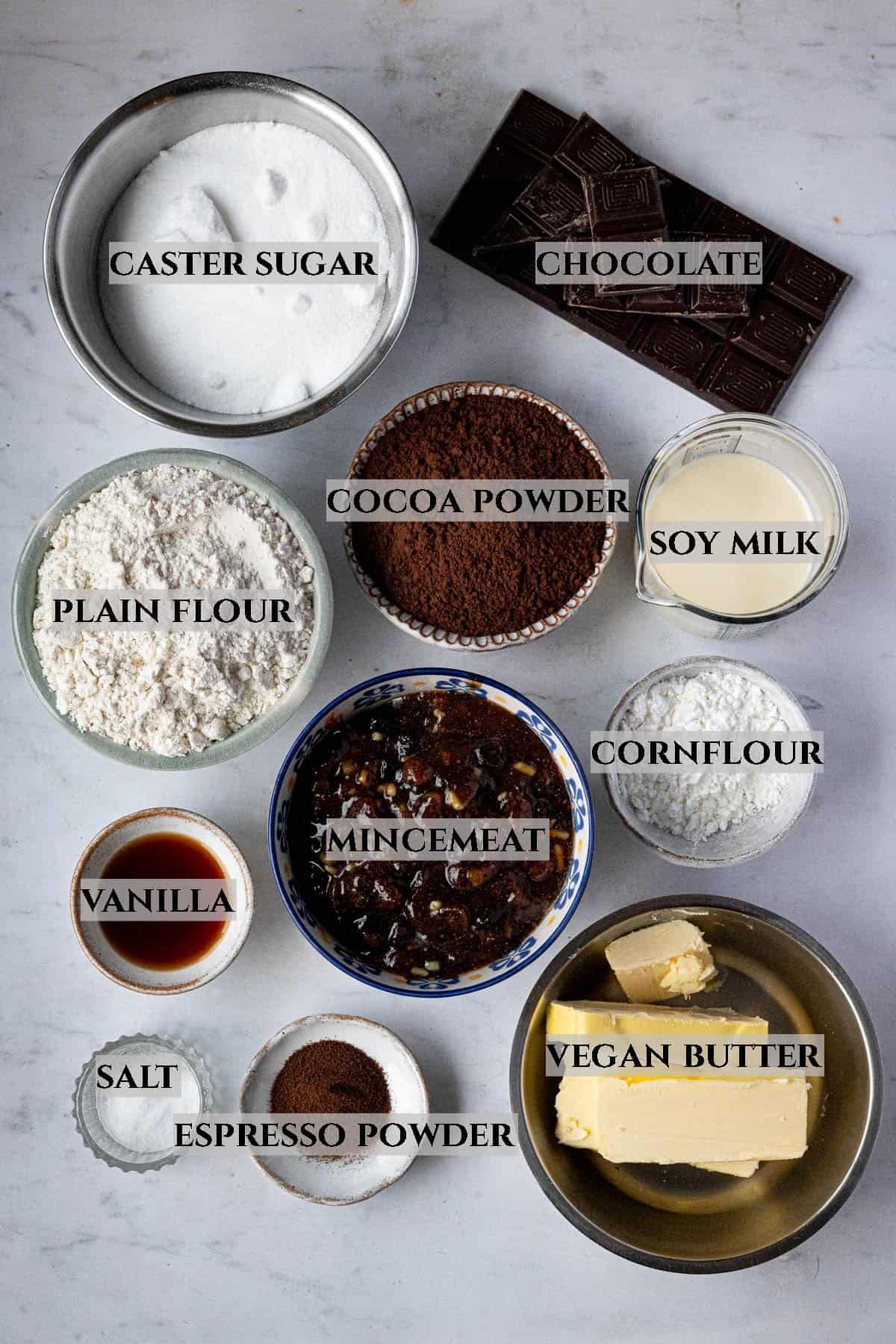 A labelled photo of the ingredients needed to make mince pie brownies in bowls.