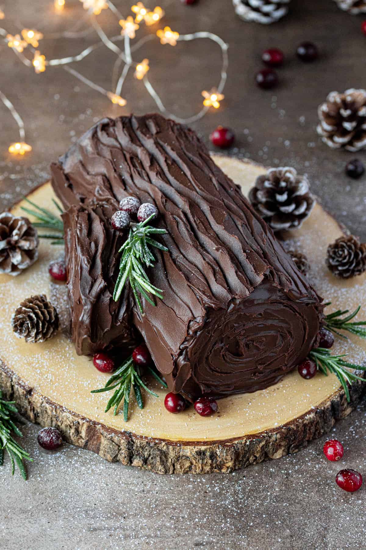 The decorated yule log on a wooden board.