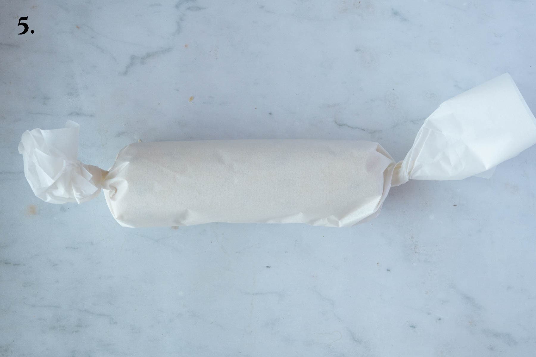 Step 5, the log of dough wrapped in baking parchment.