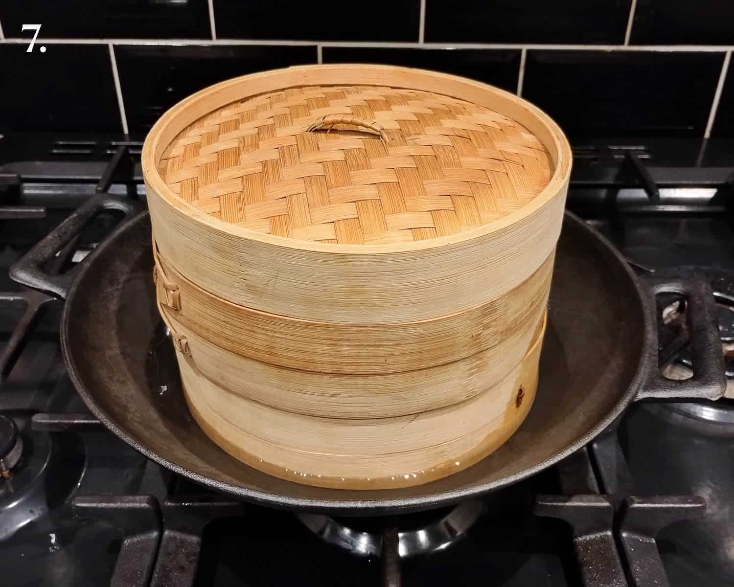 Step 7, the bamboo steamer in a wok.