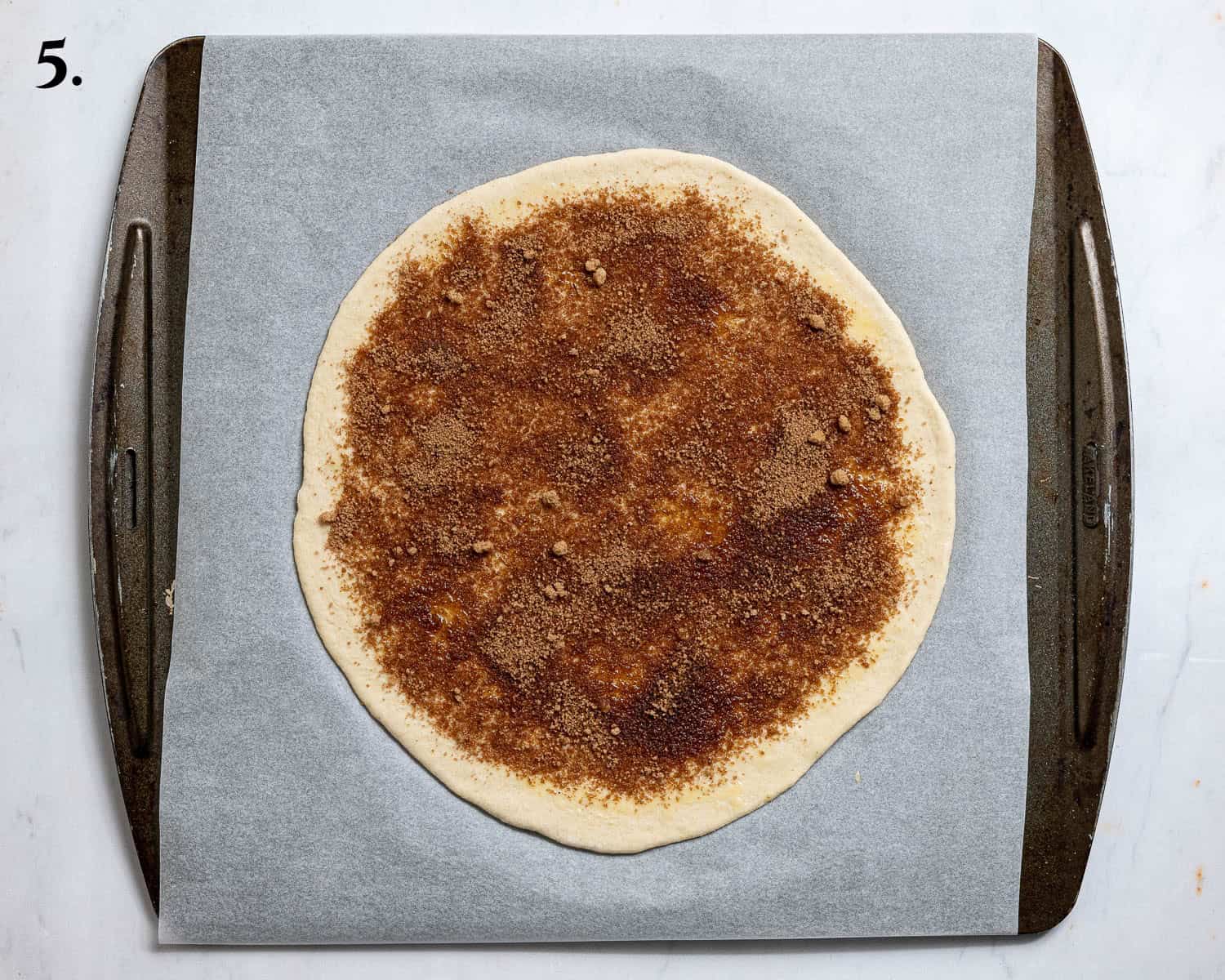 Step 5, the disc of dough topped with cinnamon sugar.