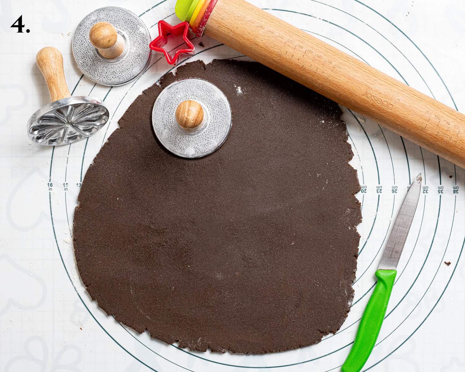 Step 4, the rolled out dough being stamped with cookie stamps.