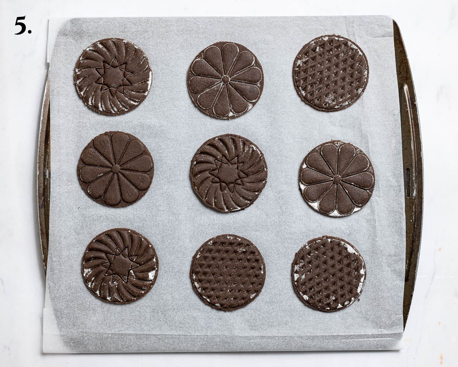 Step 5, the cut out stamped cookies on the baking tray.