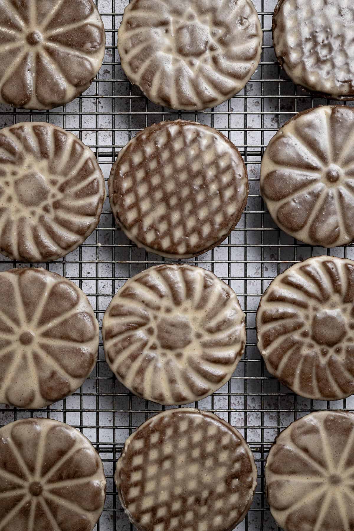 Close up of vegan glazed gingerbread cookies on a wire cooling rack.