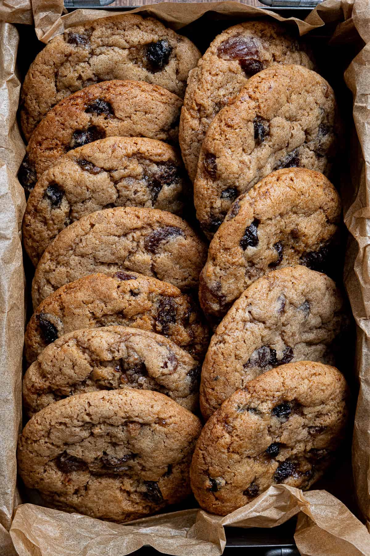 Close up of vegan mincemeat cookies in a parchment lined box.