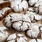 Vegan gingerbread crinkle cookies on a sheet of baking paper.