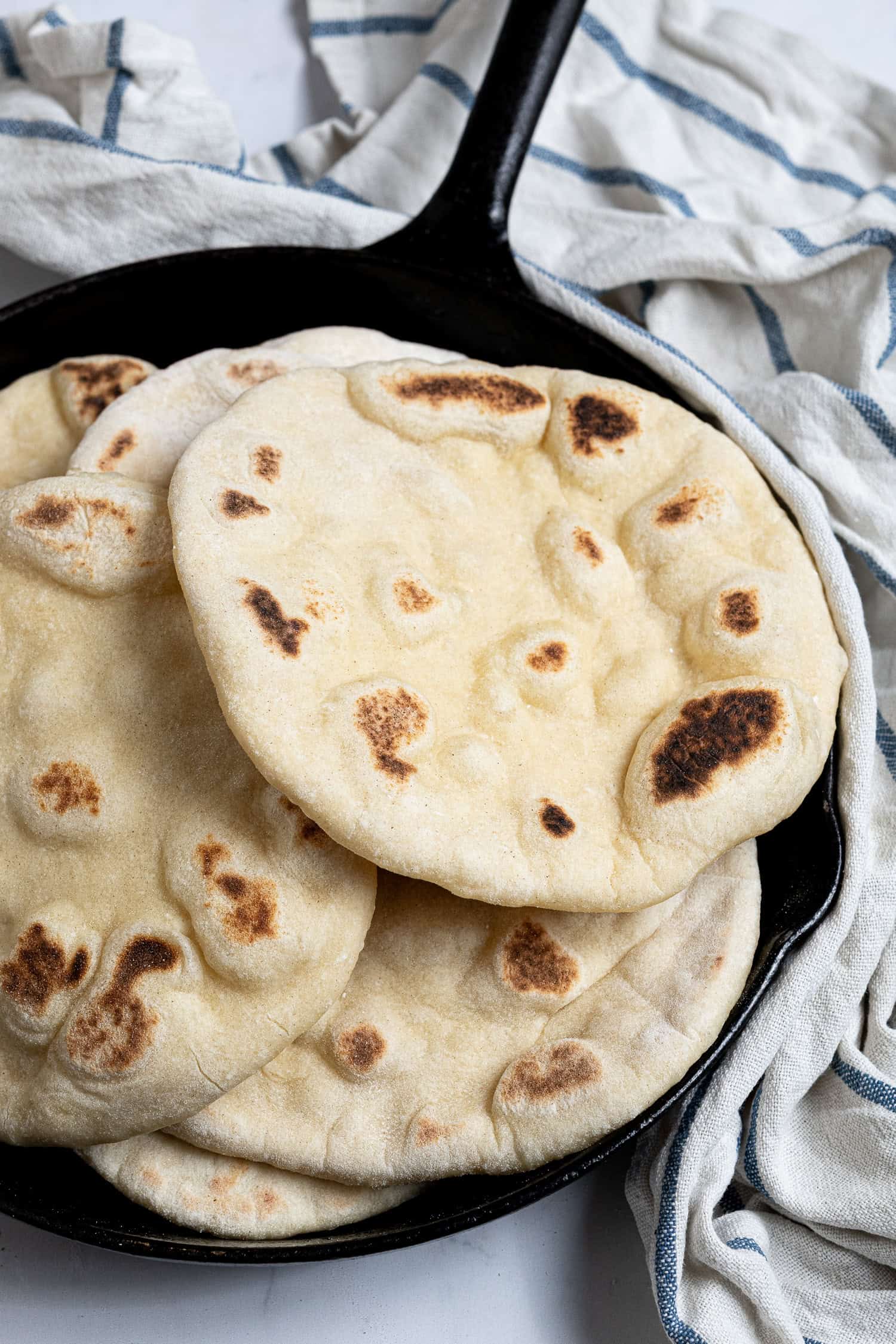 Close up of vegan yogurt flatbreads in a skillet.