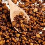 Close up of baked tofu crumbles with a wooden spoon.