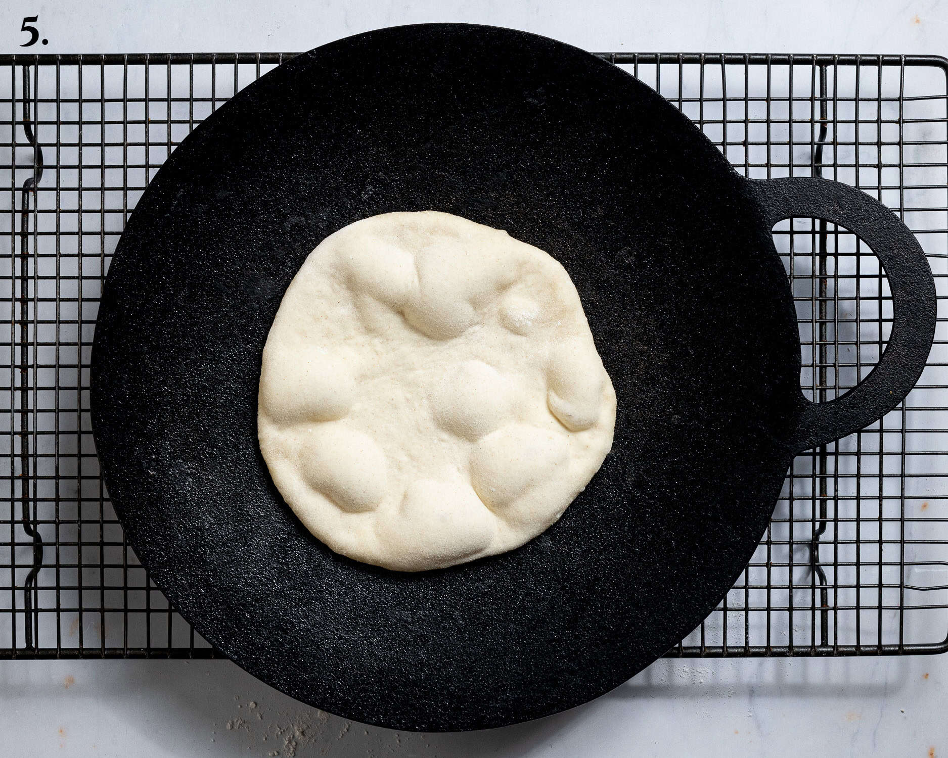 Step 5, the part-cooked flatbread in a pan.