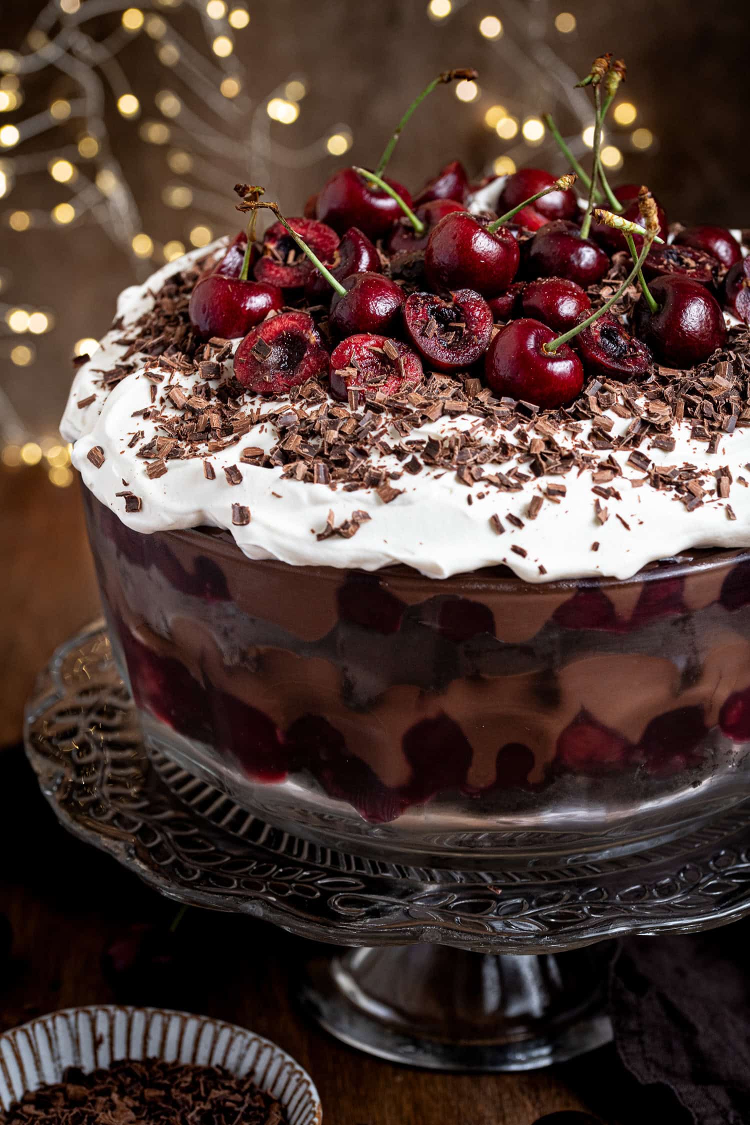 Close up of the trifle topped with cherries and chocolate shavings.