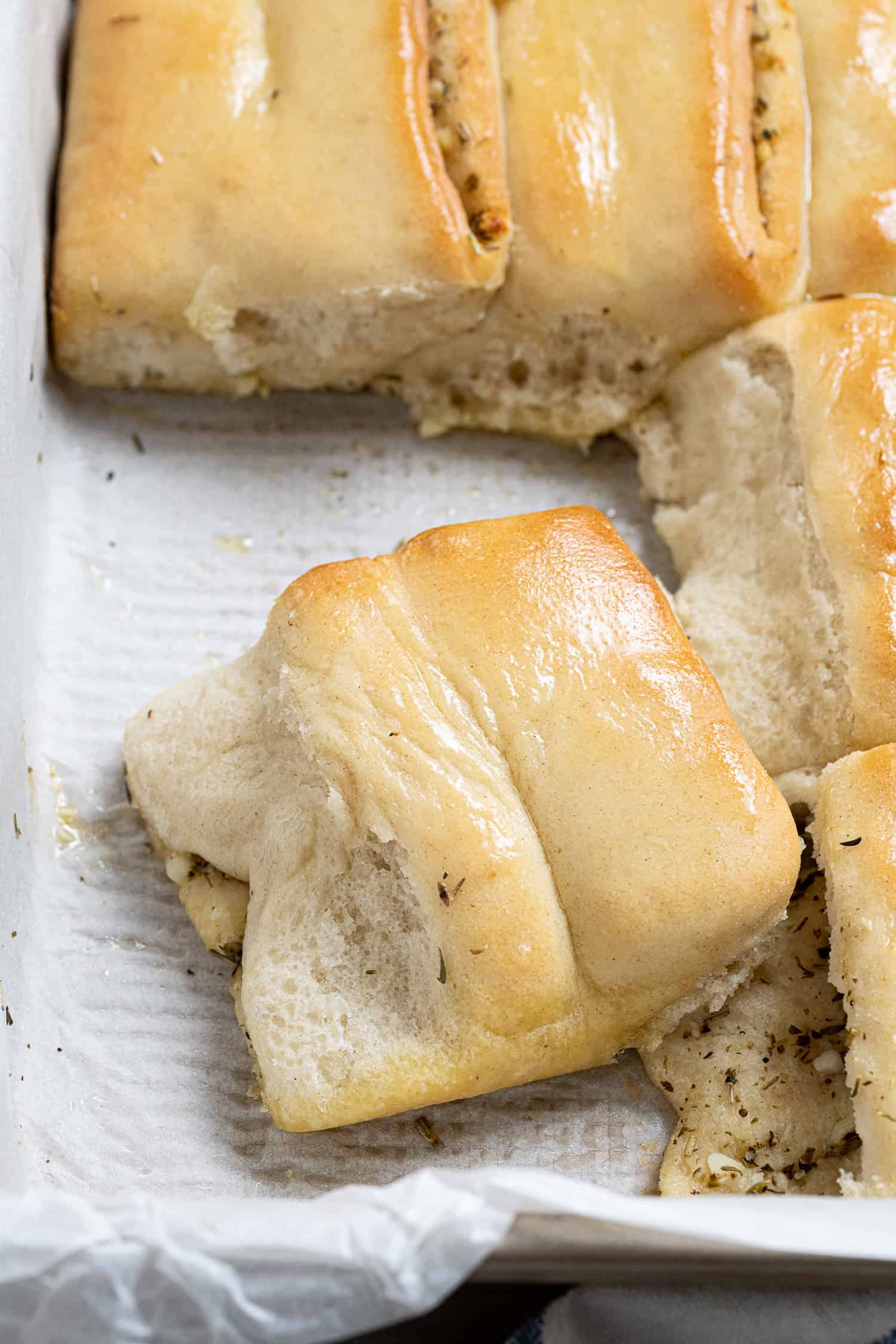 Close up of a garlic Parker House roll.