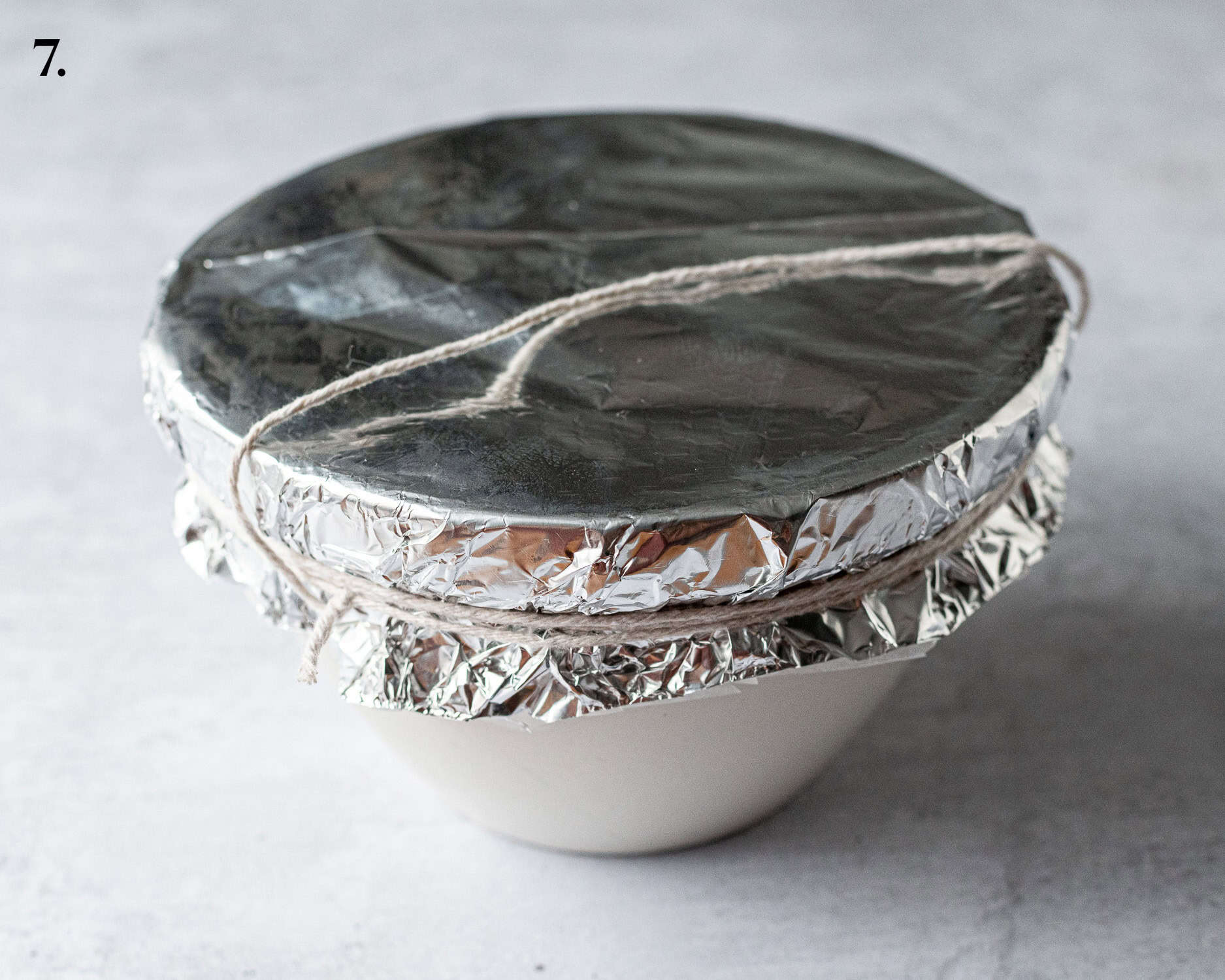 Step 7, the prepared pudding basin tied with string.