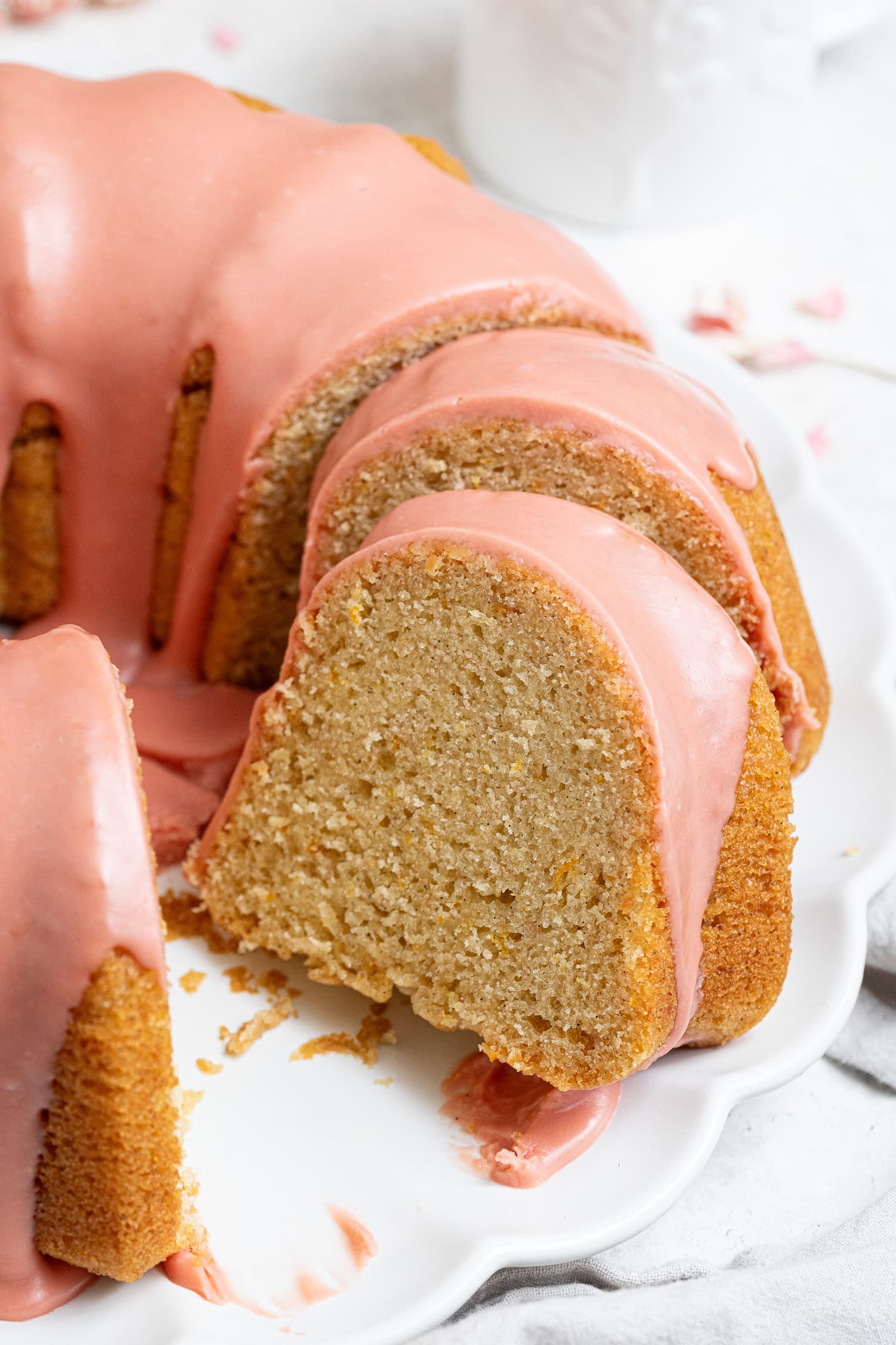 Close up of a slice of vegan blood orange olive oil bundt cake.