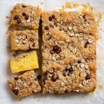 Vegan peach crumble cake with four slices cut.