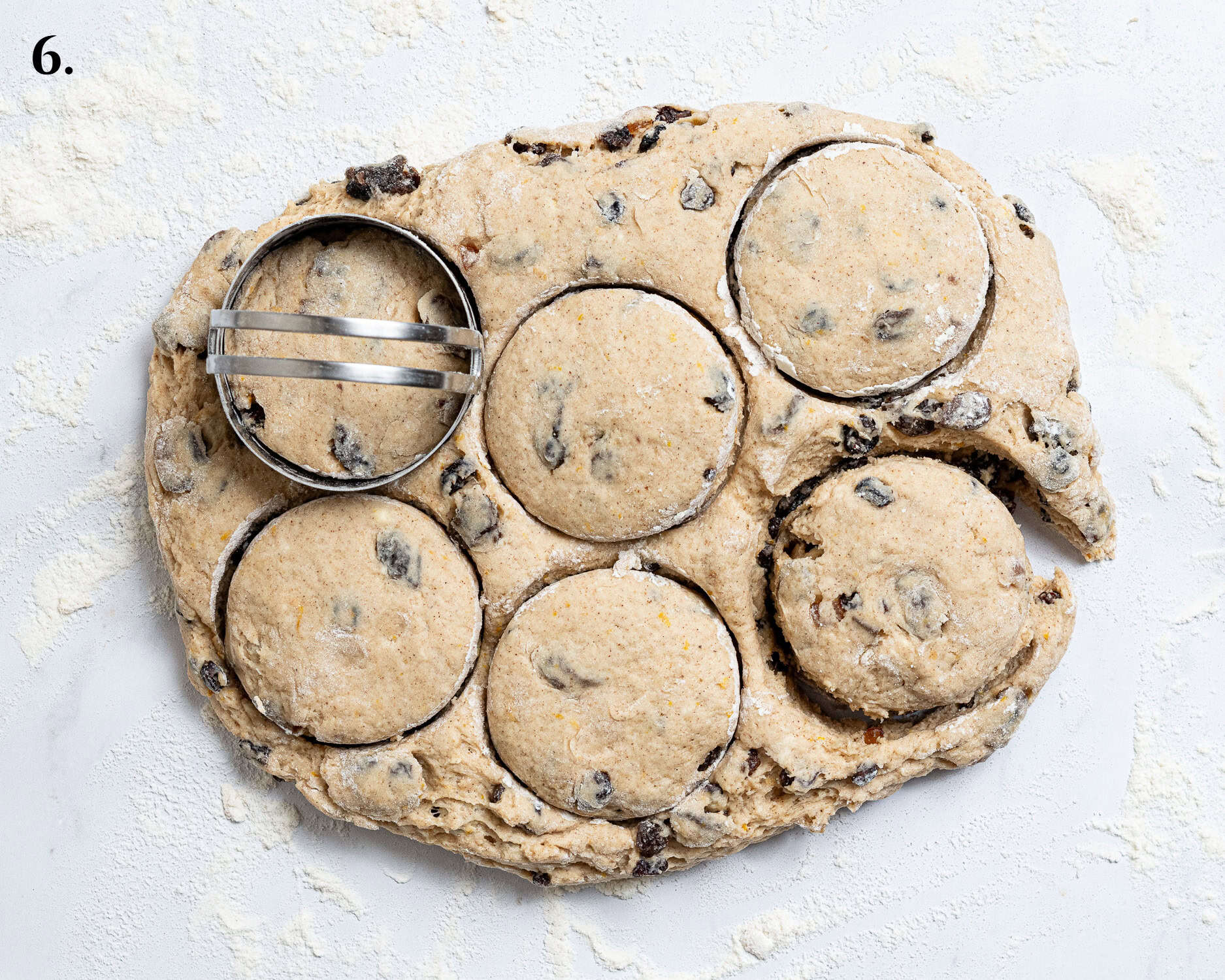 Syep 6, cutting rounds out of the patted out dough.