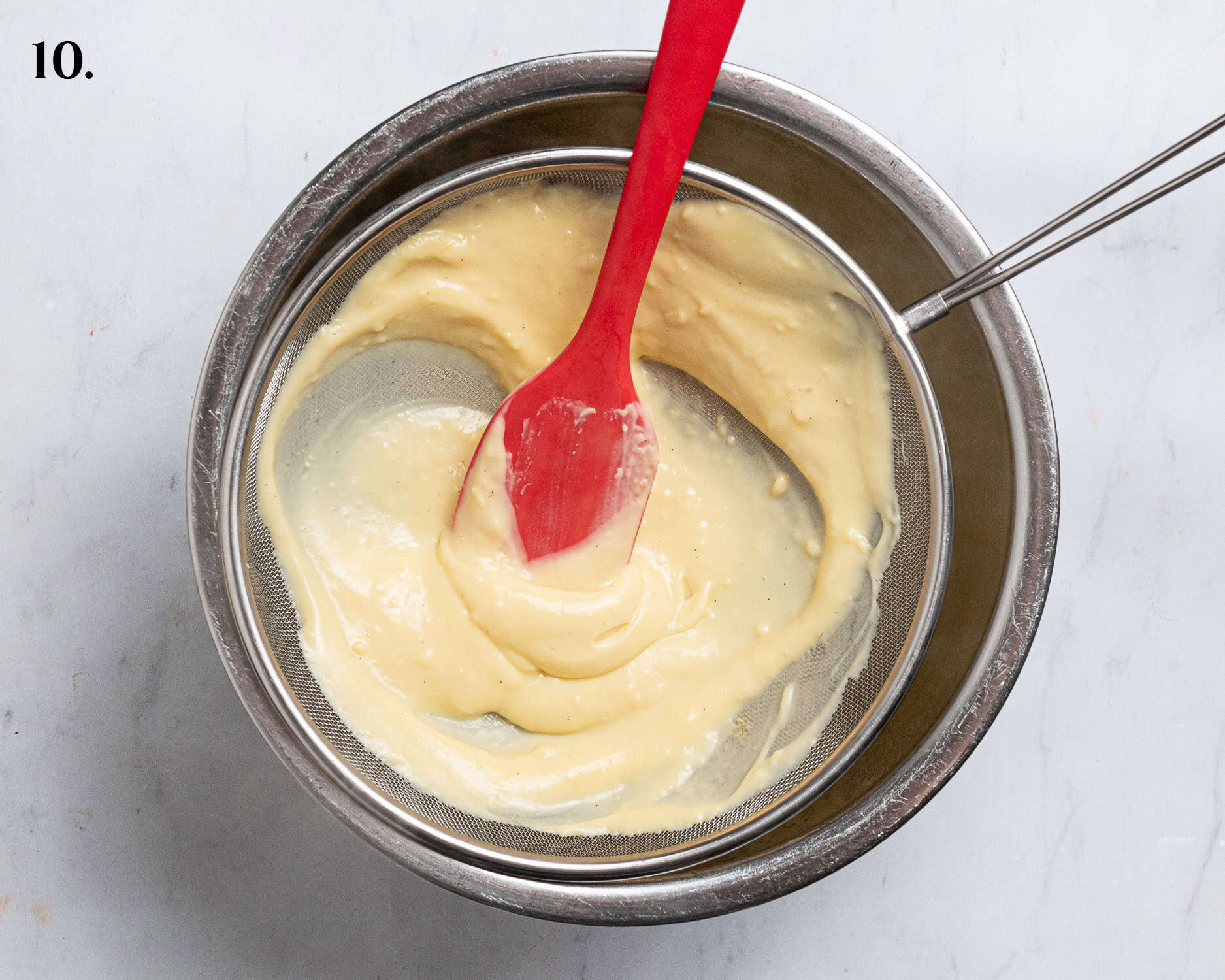 Step 10, scraping the custard through a sieve.
