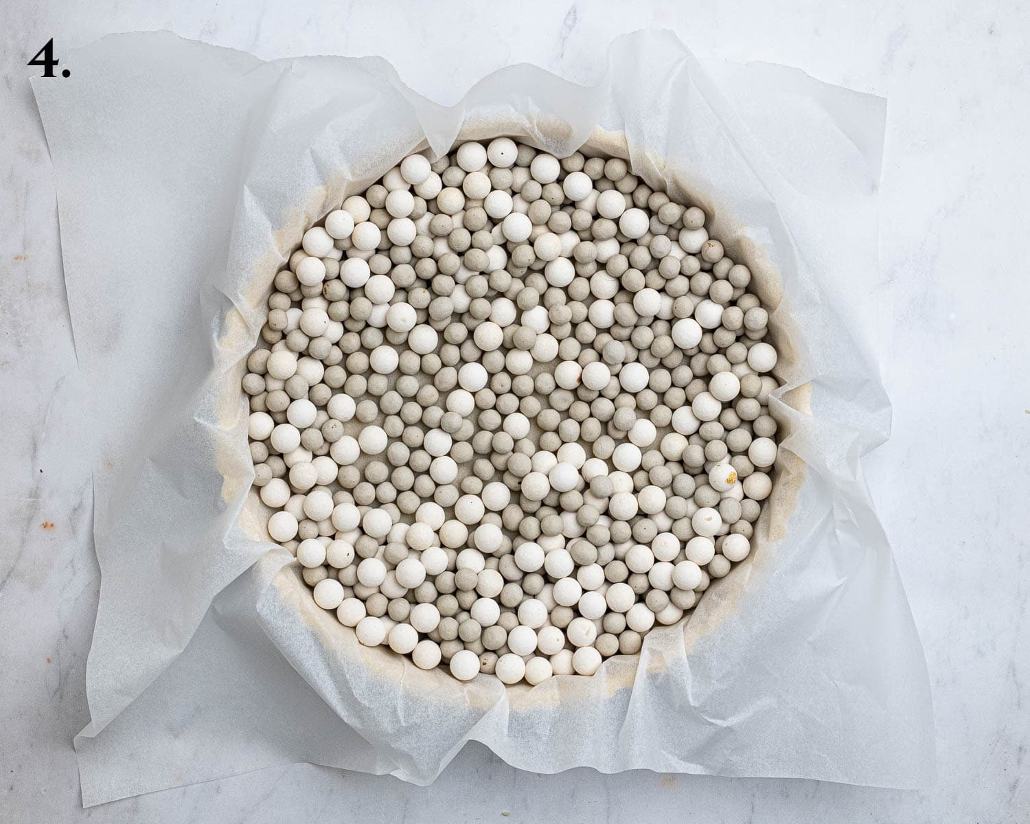 Step 4, the pastry case filled with baking beans.