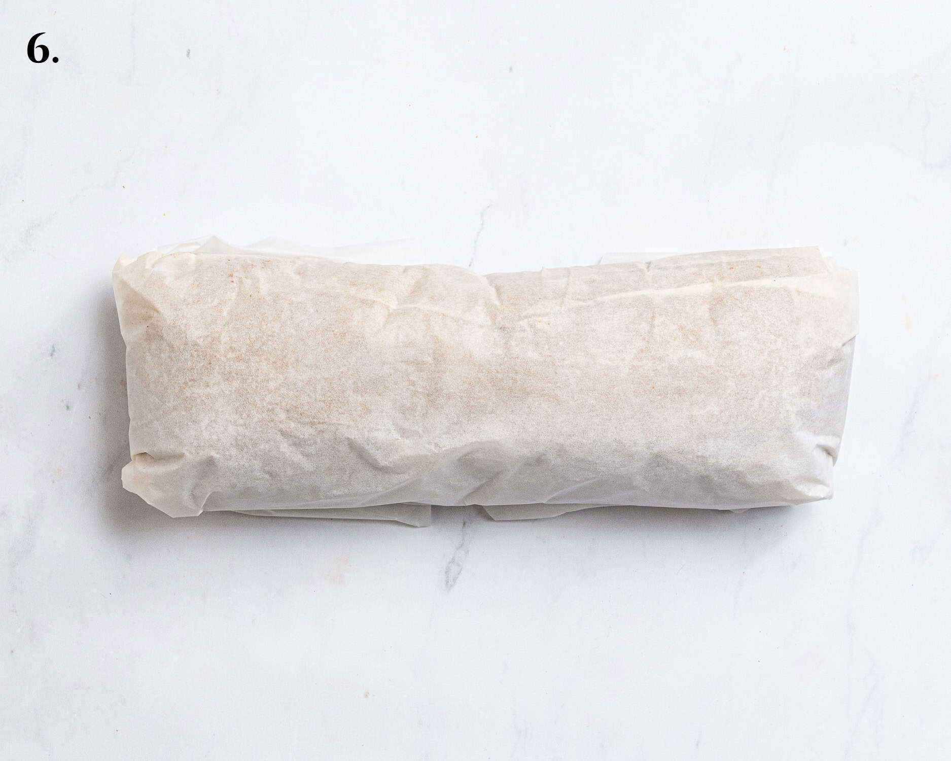 Step 6, the dough wrapped in baking paper.