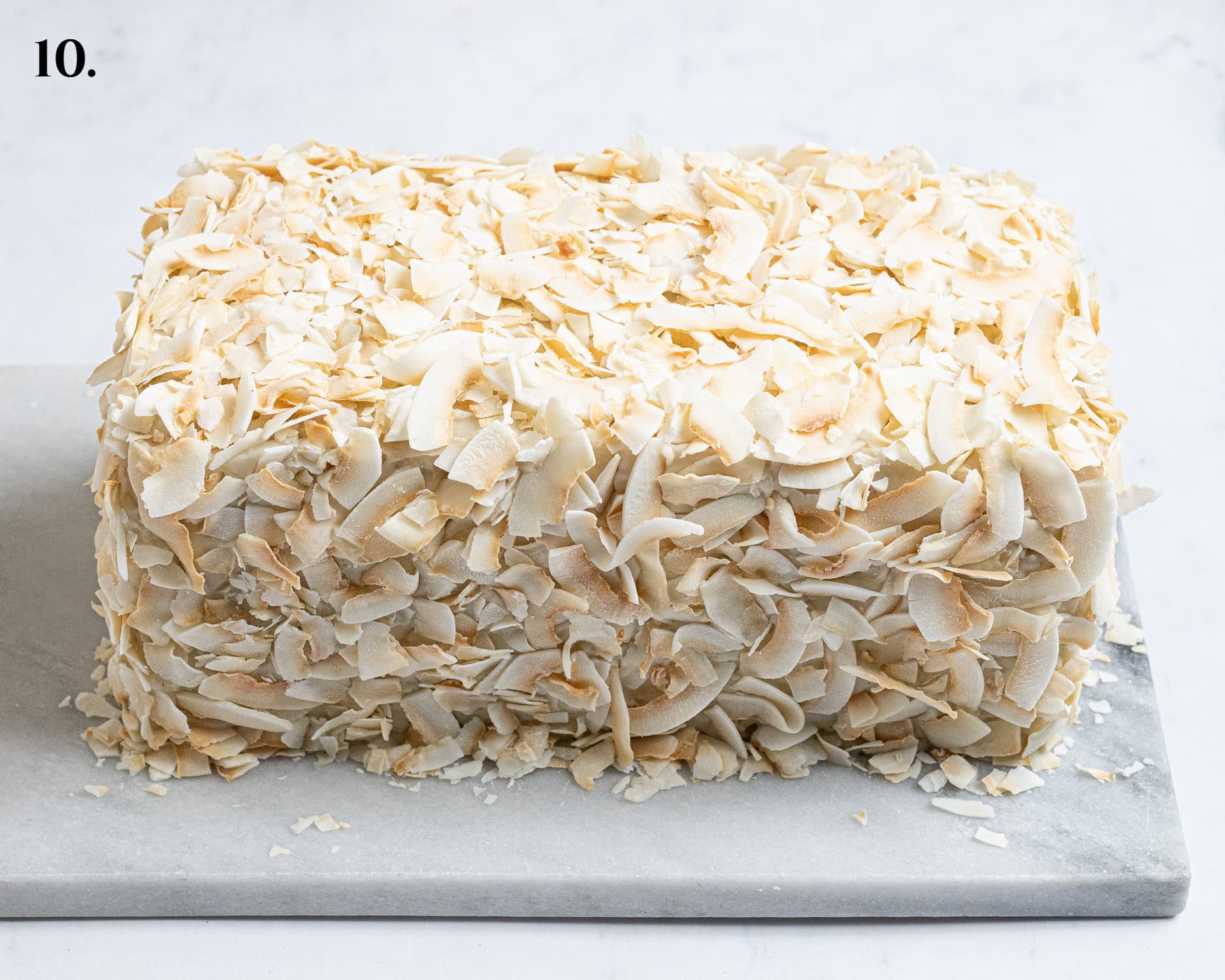 Step 10, the cake covered in coconut flakes.