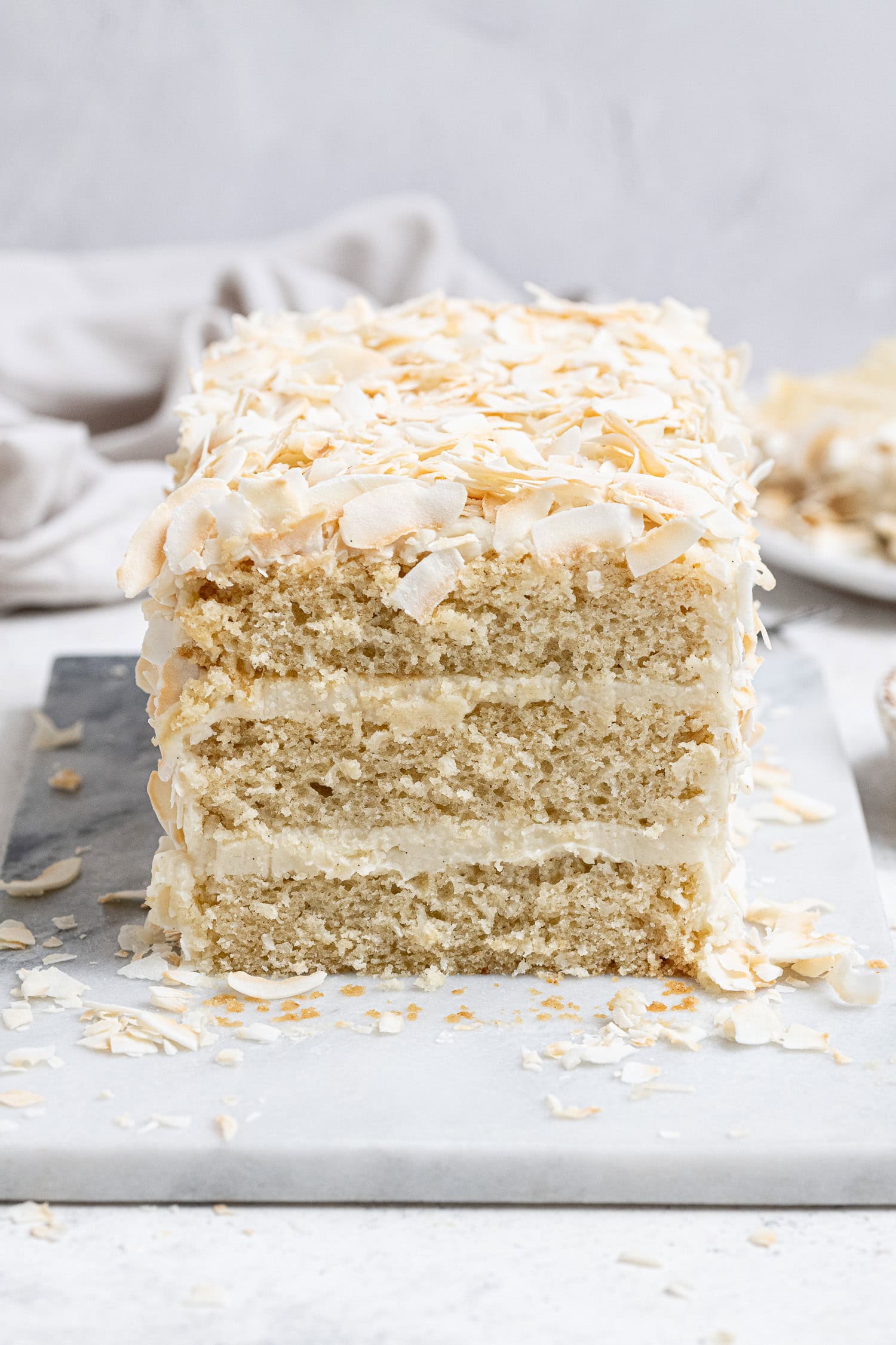 Vegan coconut cream cake on a marble board.