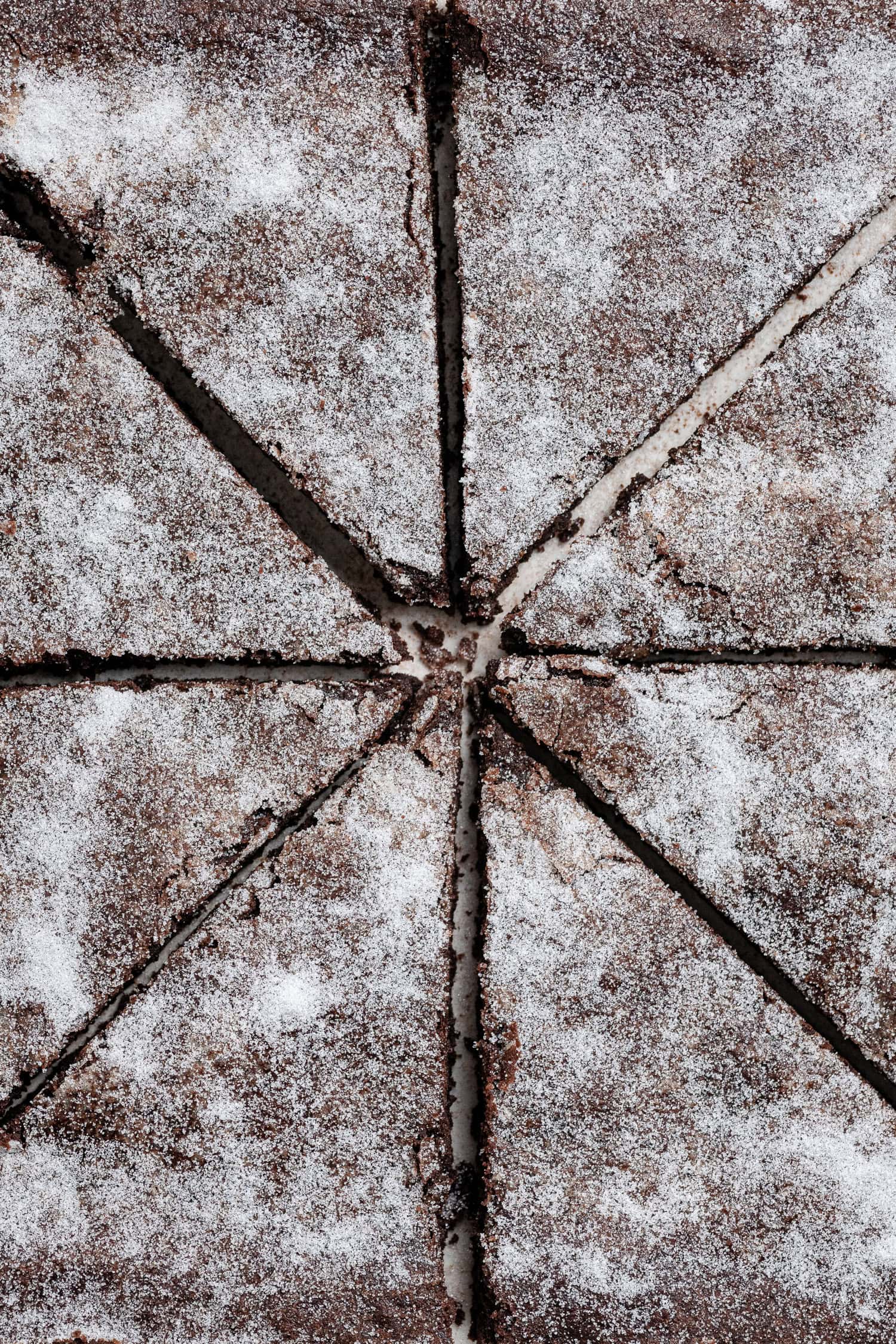 Close up shot of a slab of vegan chocolate concrete sliced into triangles.