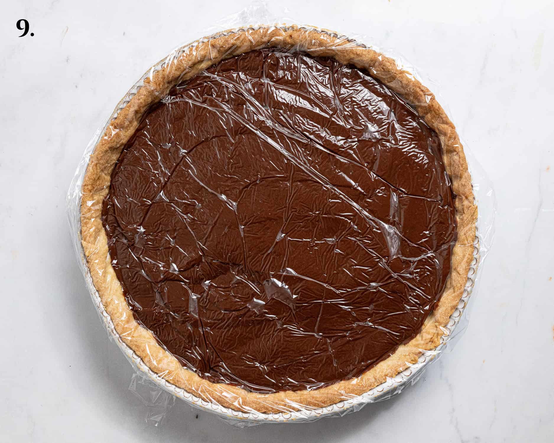 Step 9, the chocolate pudding in the pastry case covered with clingfilm.