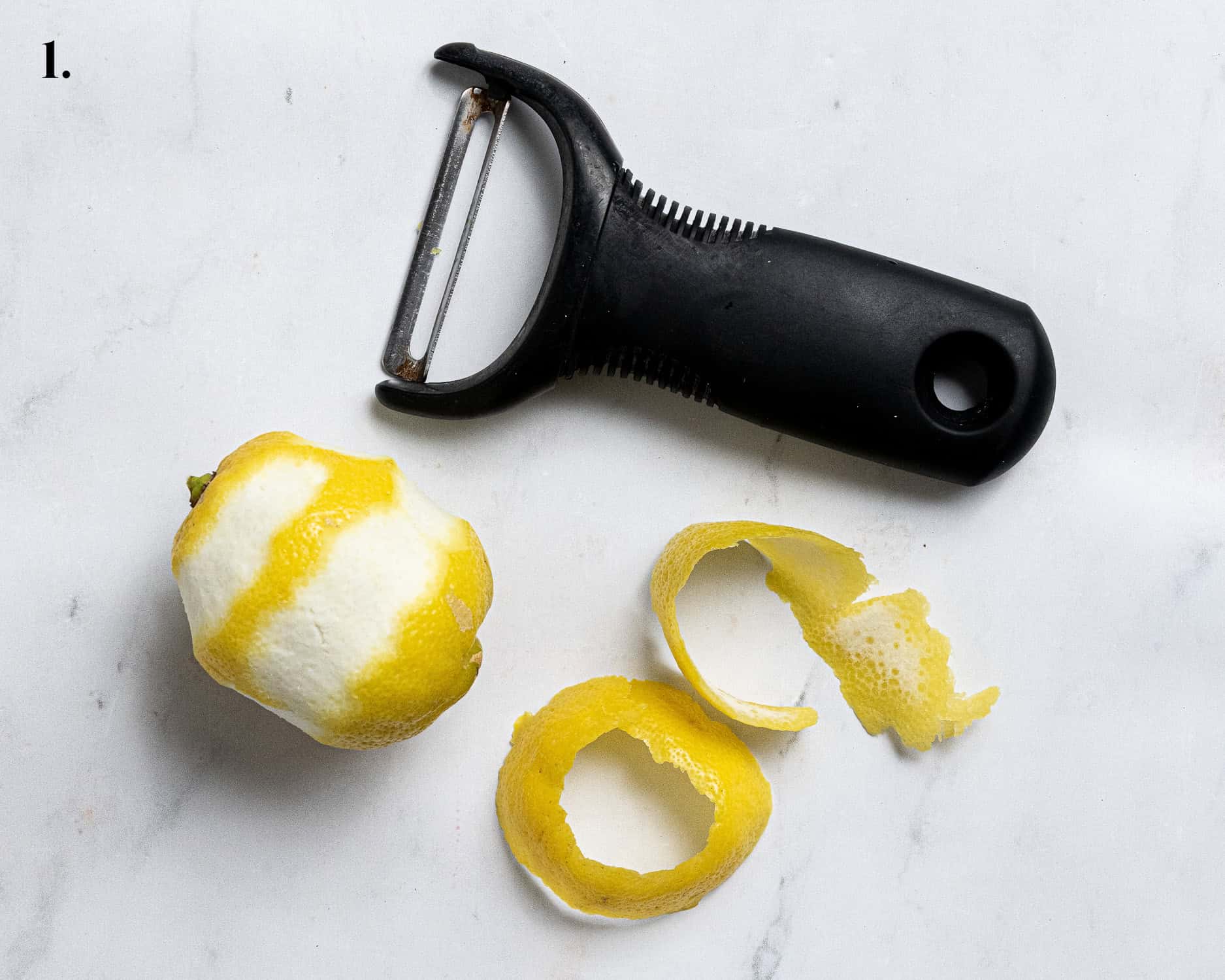 Step 1, peeling the lemon zest.