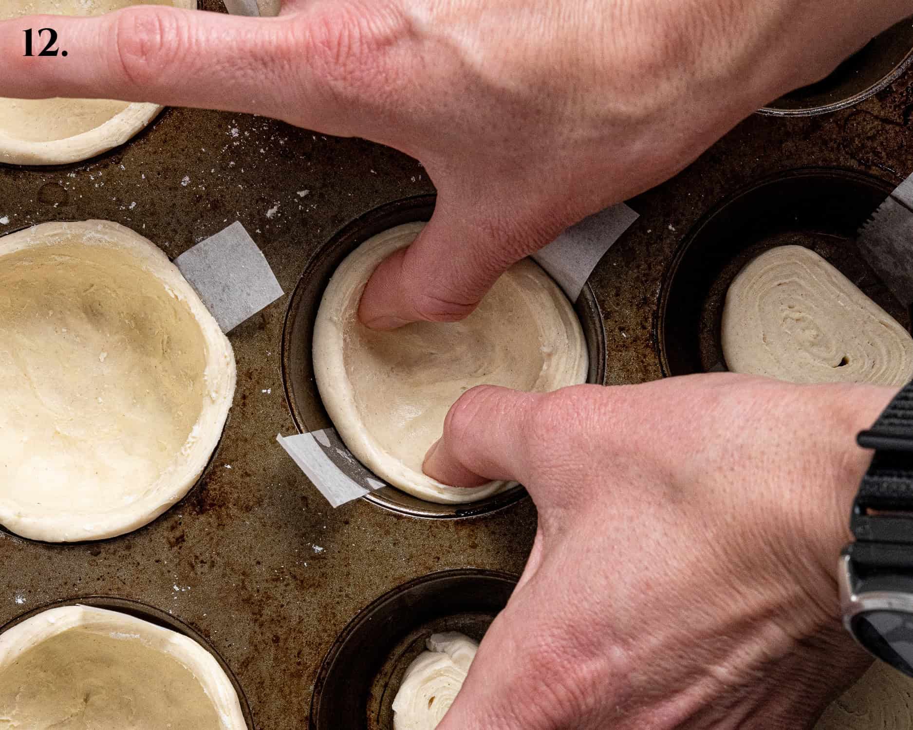 Step 12, a pair of hands smoothing the pastry up the sides of the tin.