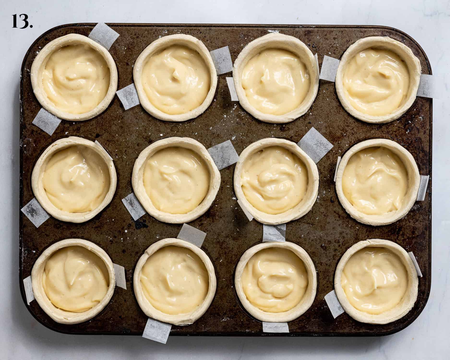 Step 13. the custard divided between the pastry cases.