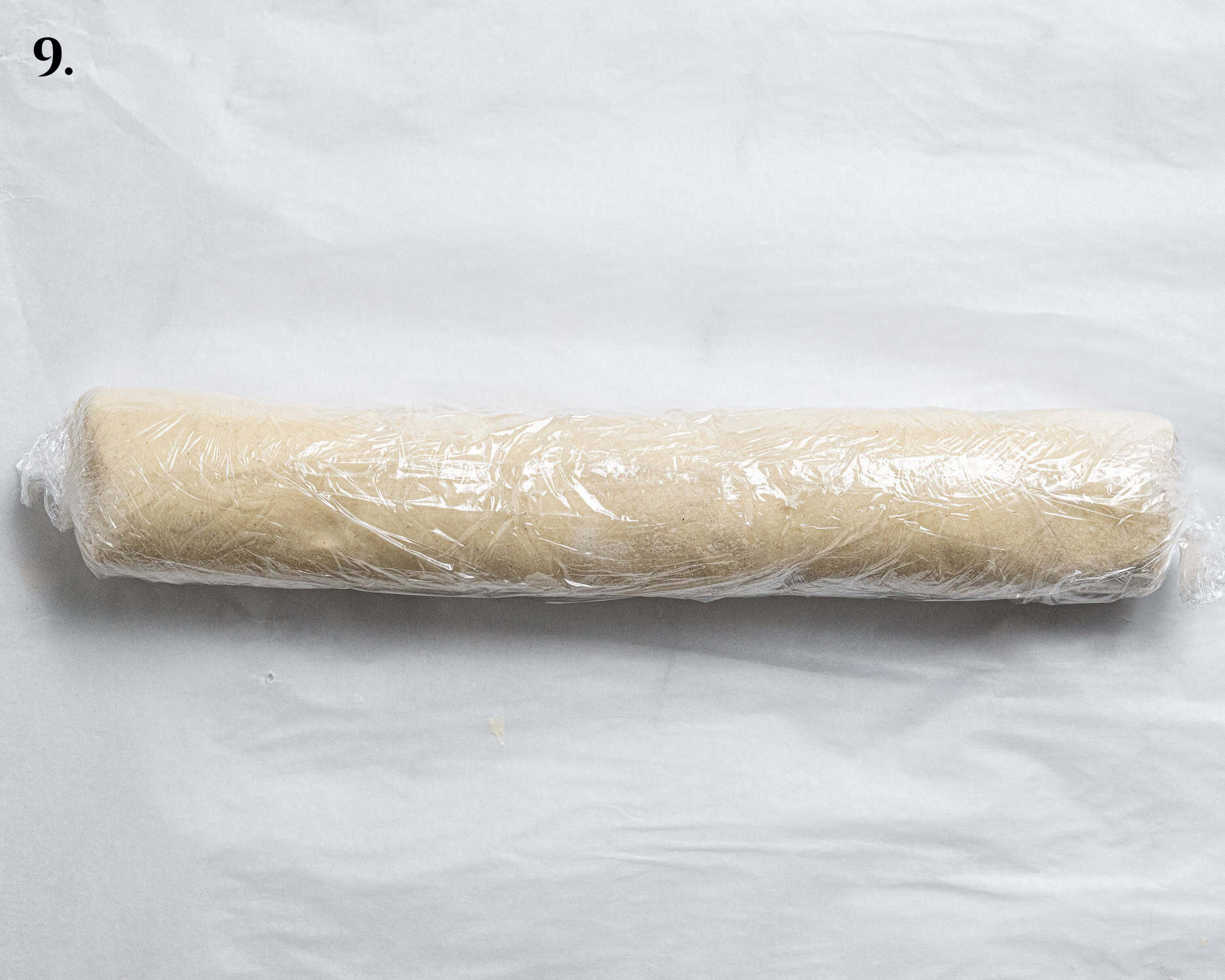 Step 9, the pastry log wrapped in clingfilm.