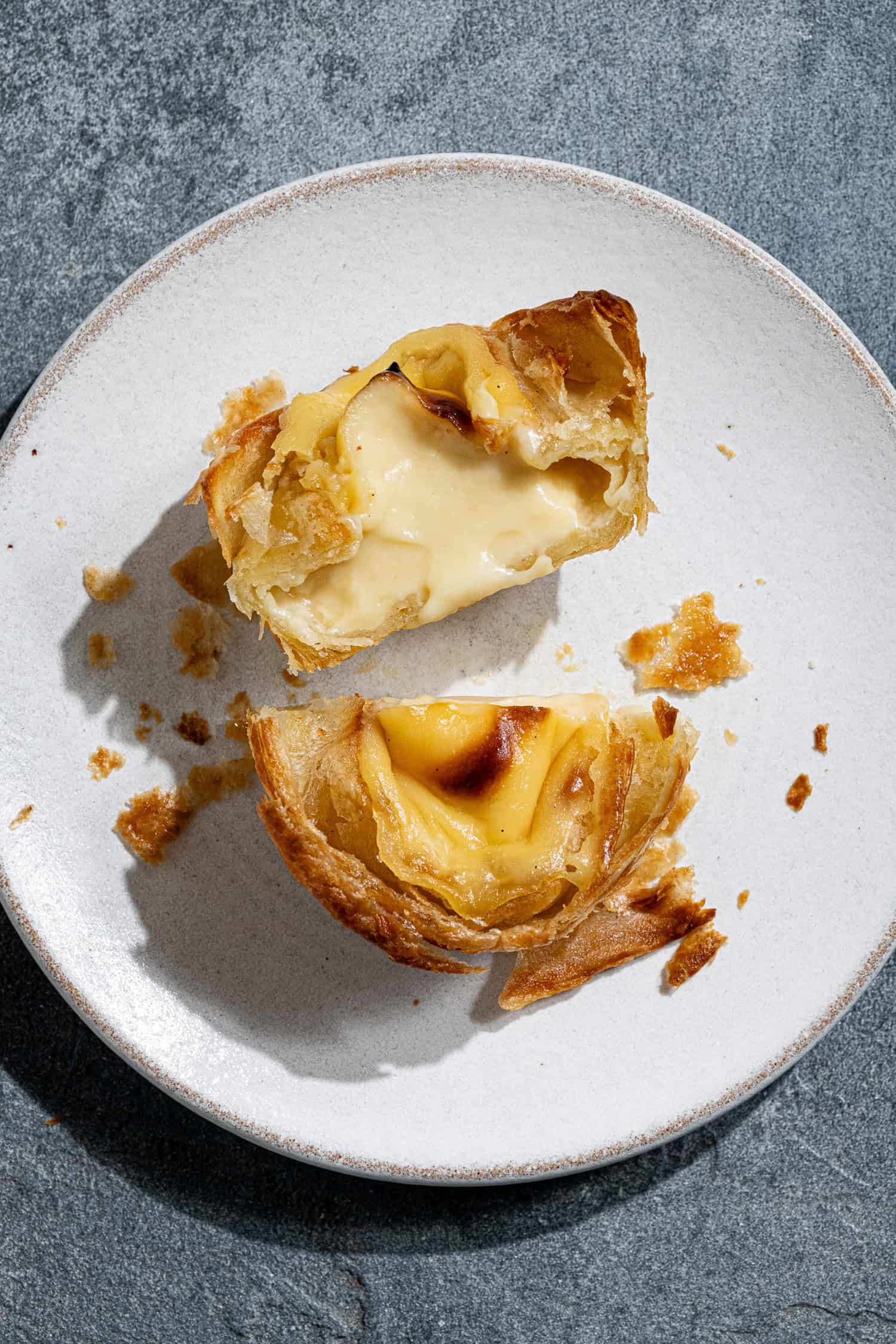 A vegan pastel de nata sliced in half.