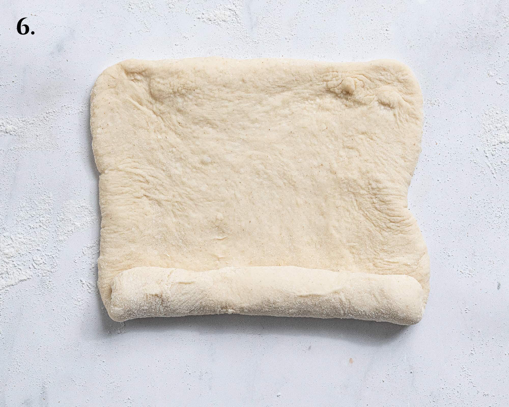 Step 6, rolling up the rectangle of dough.