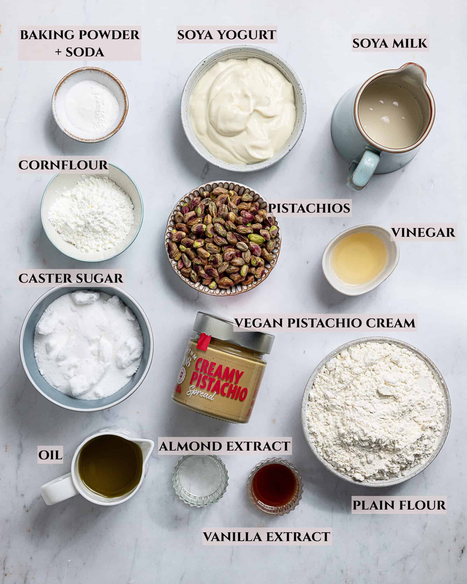 A labelled photo of the ingredients needed to make vegan pistachio loaf cake.