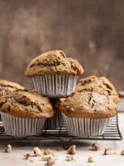 A stack of vegan courgette muffins on a wire cooling rack.