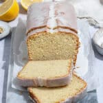 Sliced vegan lemon cardamom pound cake on a marble board.