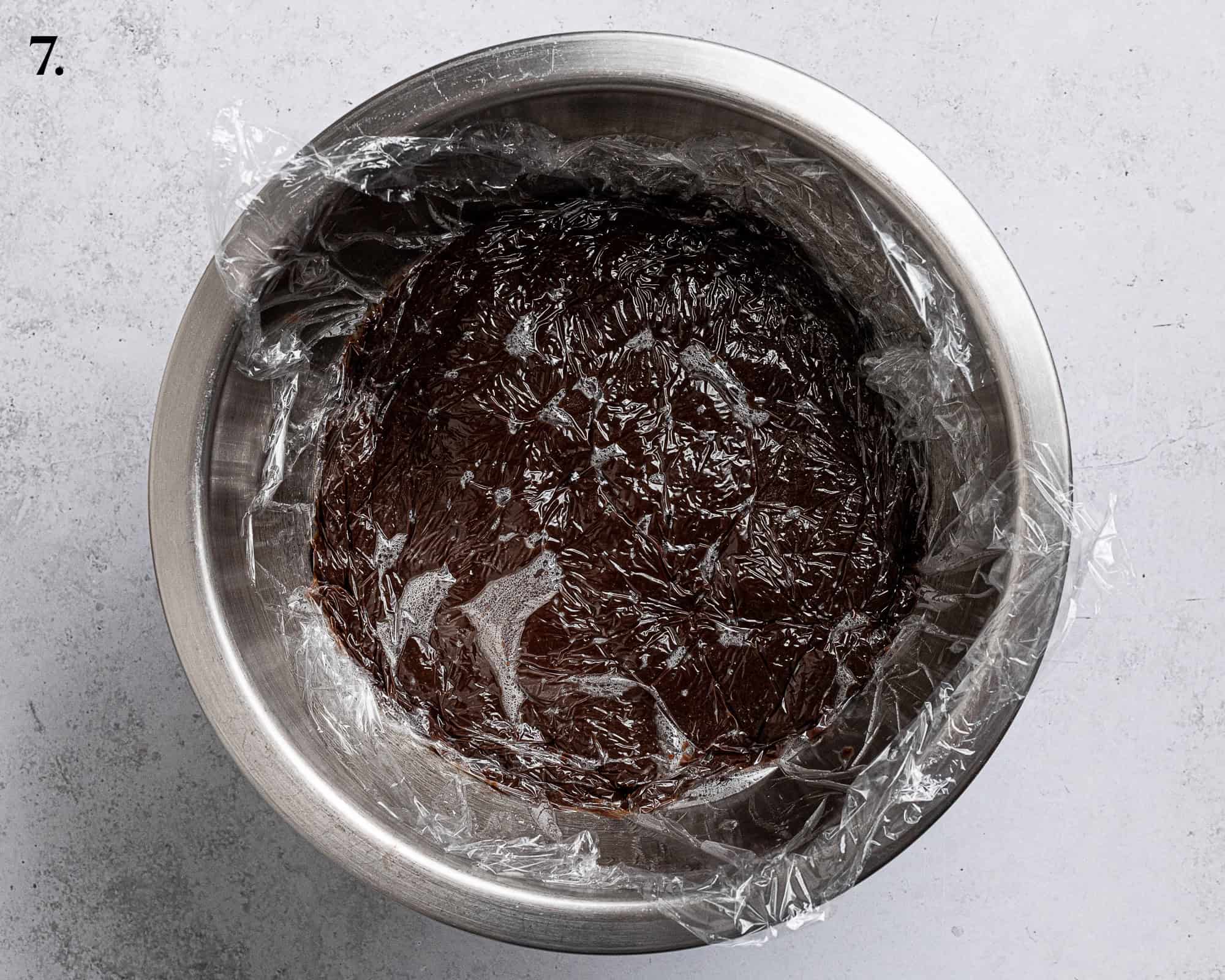 Step 7, the pudding in a bowl covered with clingfilm.
