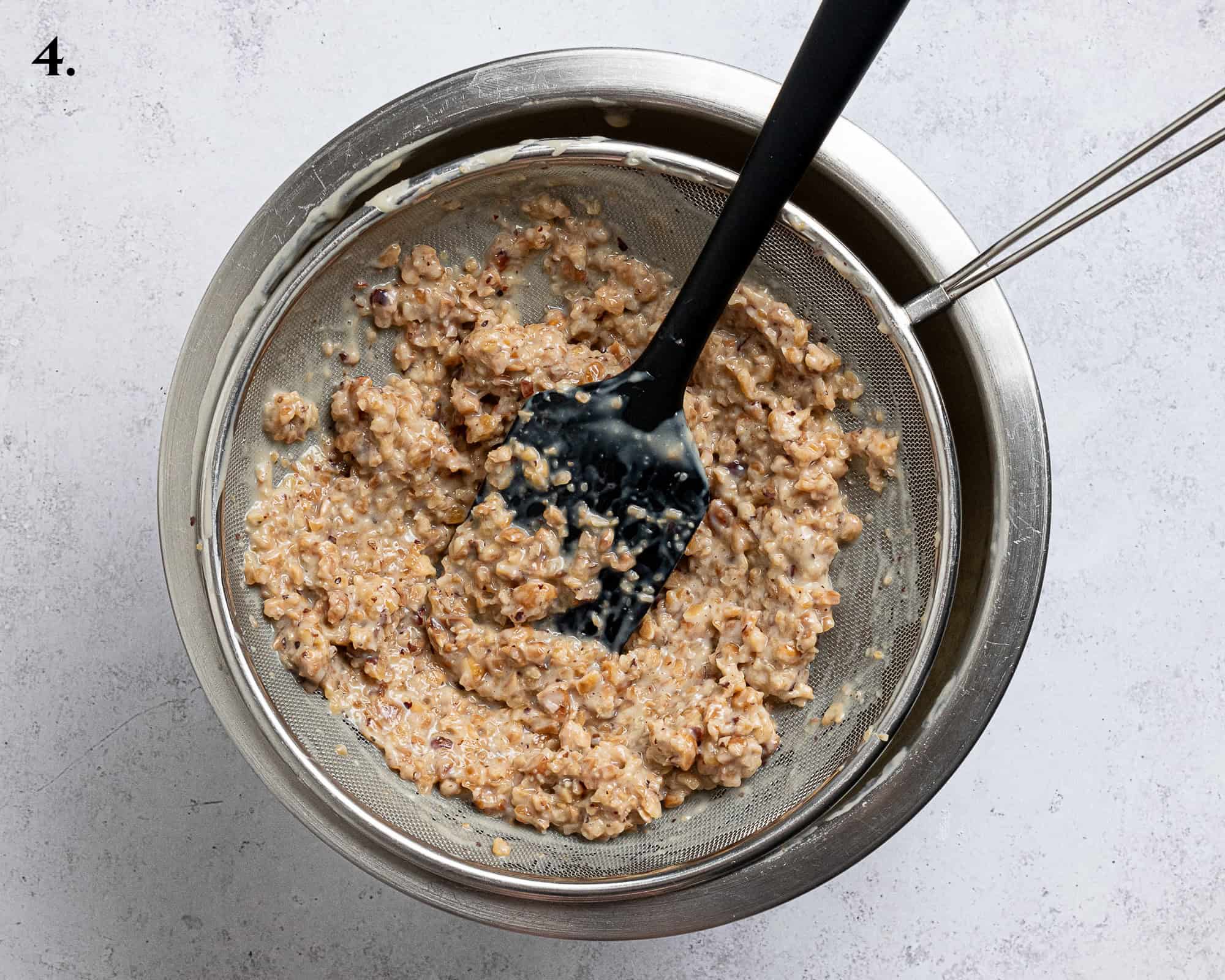 Step 4, straining out the hazelnuts in a sieve.