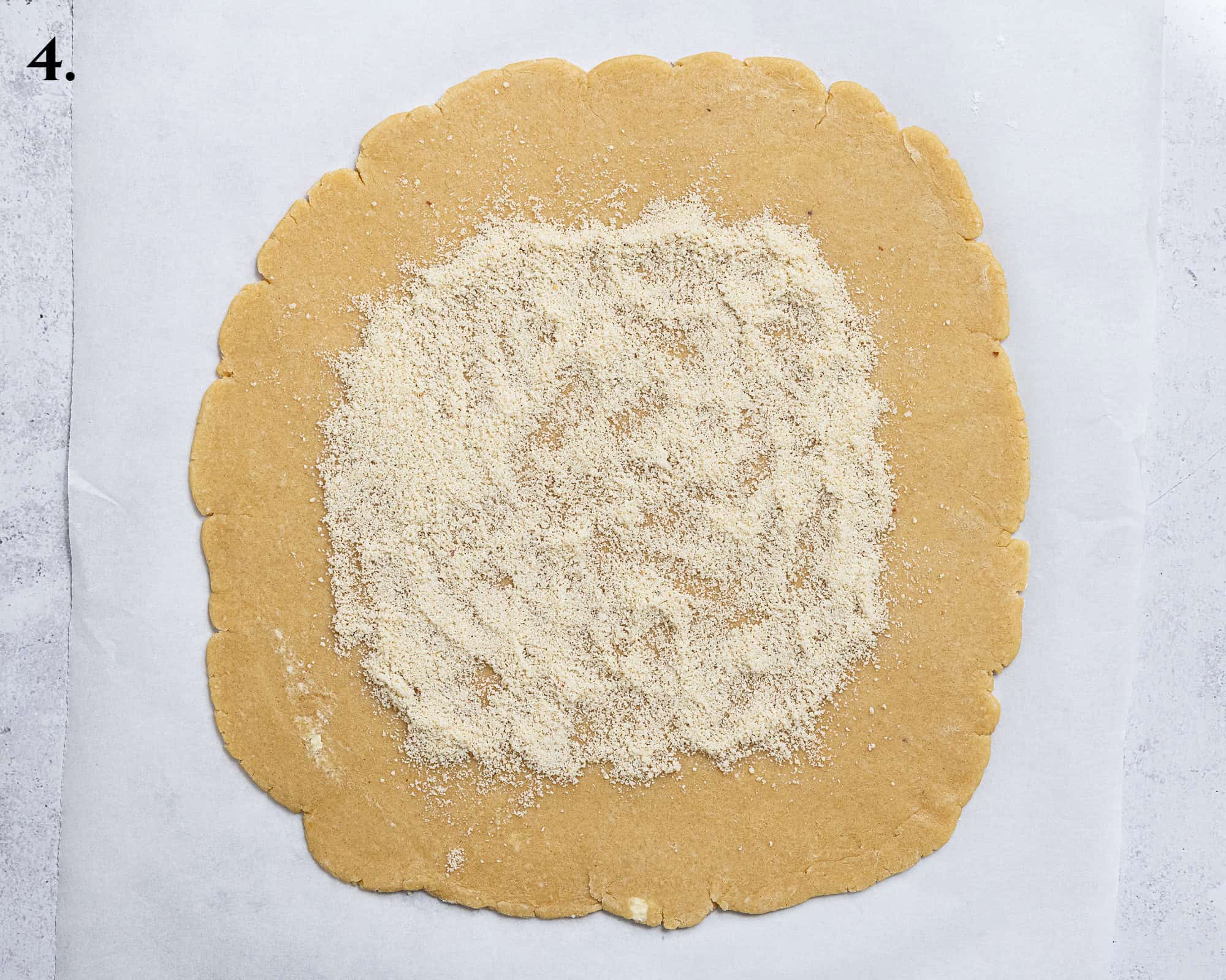 Step 4, the rolled out pastry with the ground almonds on top.