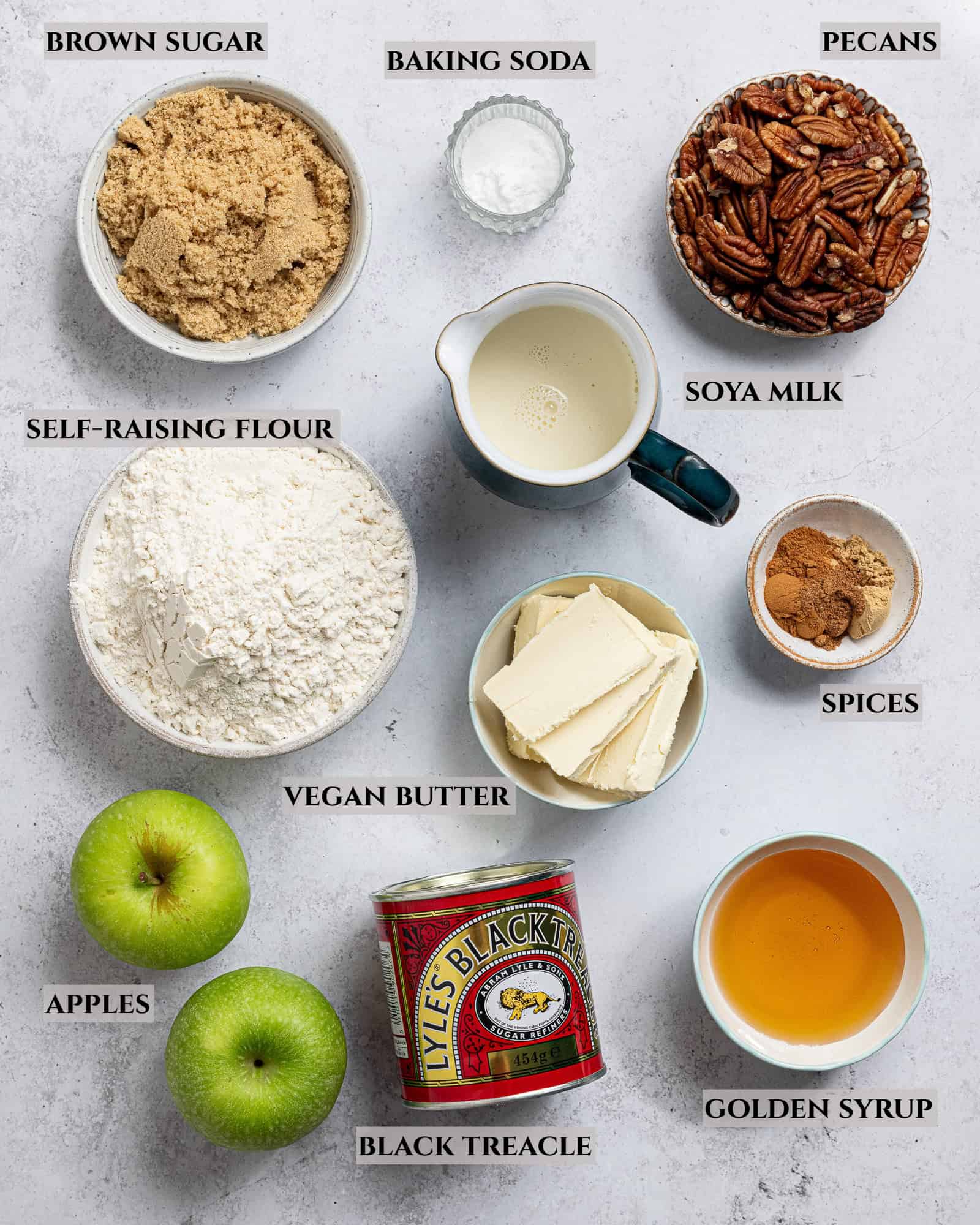 A labelled photo of the ingredients needed to make vegan apple gingerbread cake.