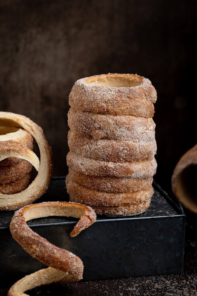 A vegan chimney cake on top of a metal box.