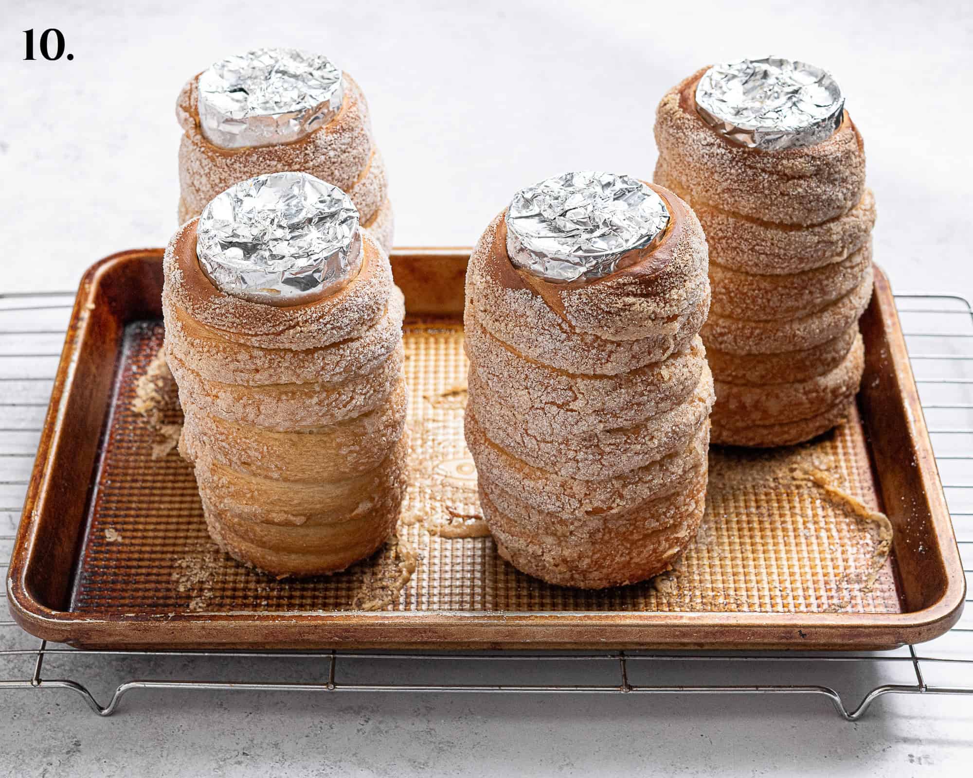 Step 10, the baked chimney cakes on a baking tray.