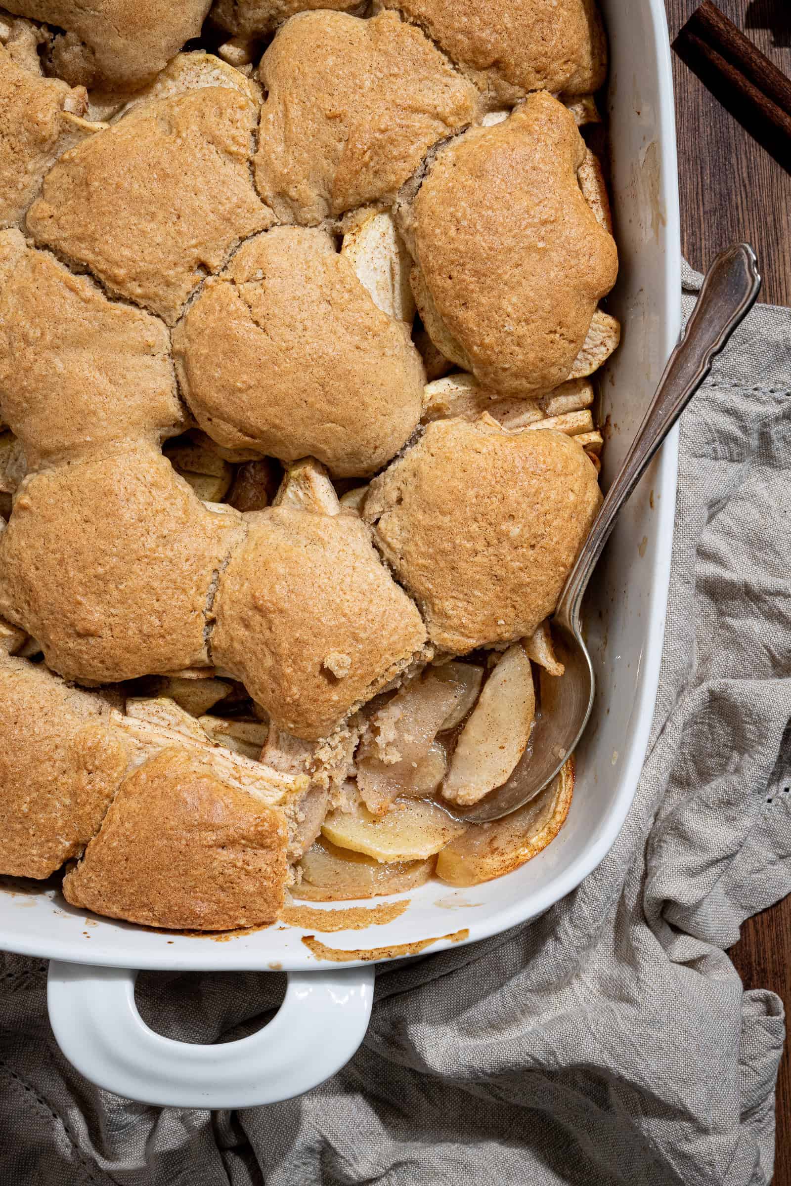 Close up shot of the vegan apple cobbler with a spoonful removed.