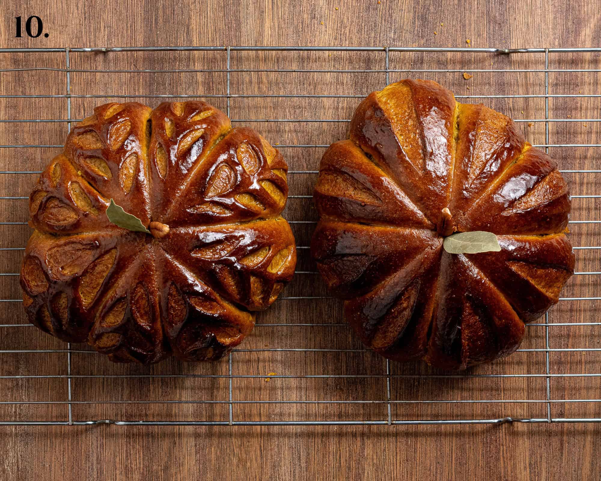 Step 10, the baked loaves with the strings removed, brushed with butter and decorated with pecan halves and bay leaves.