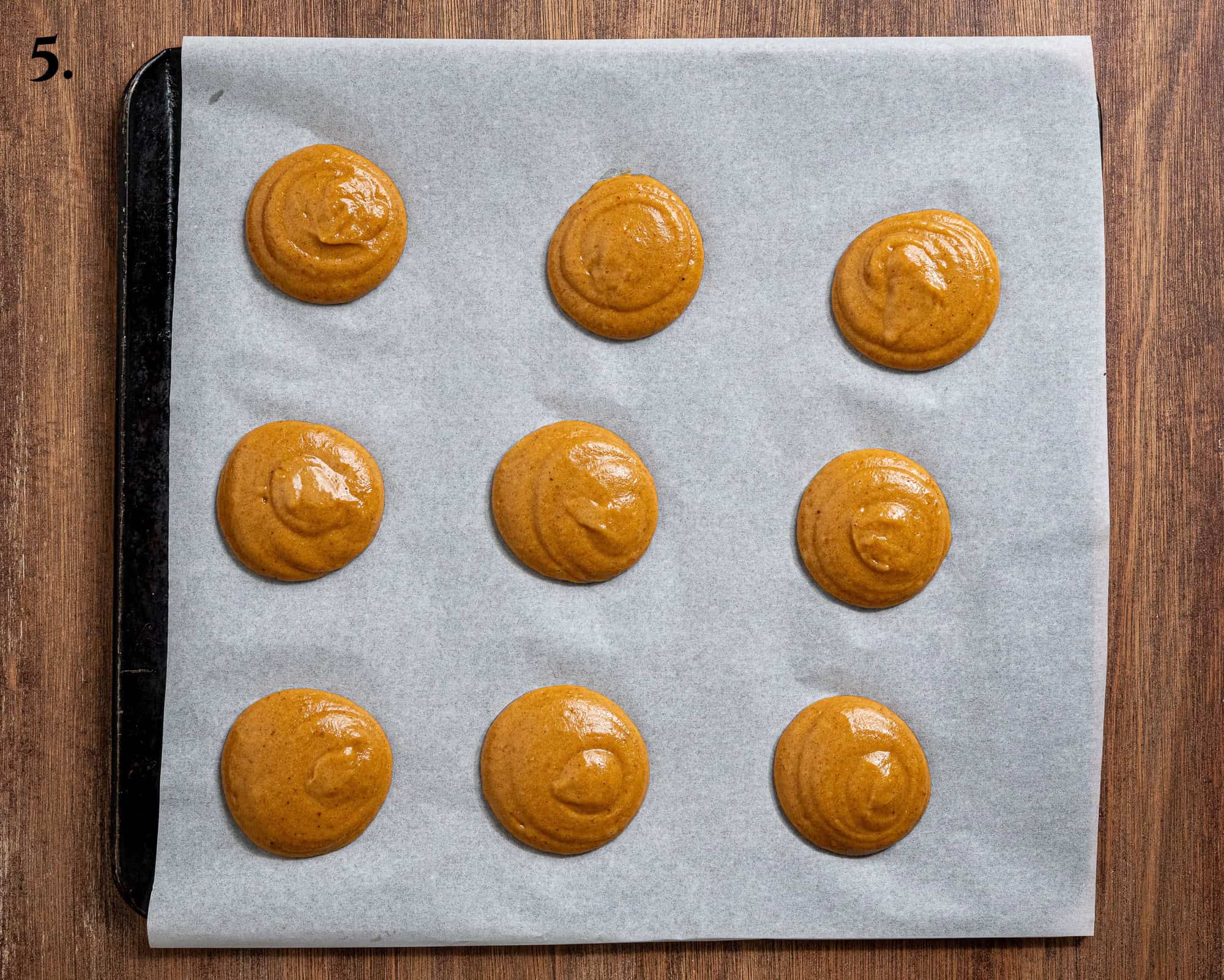 Step 5, the batter piped in rounds onto a baking sheet.