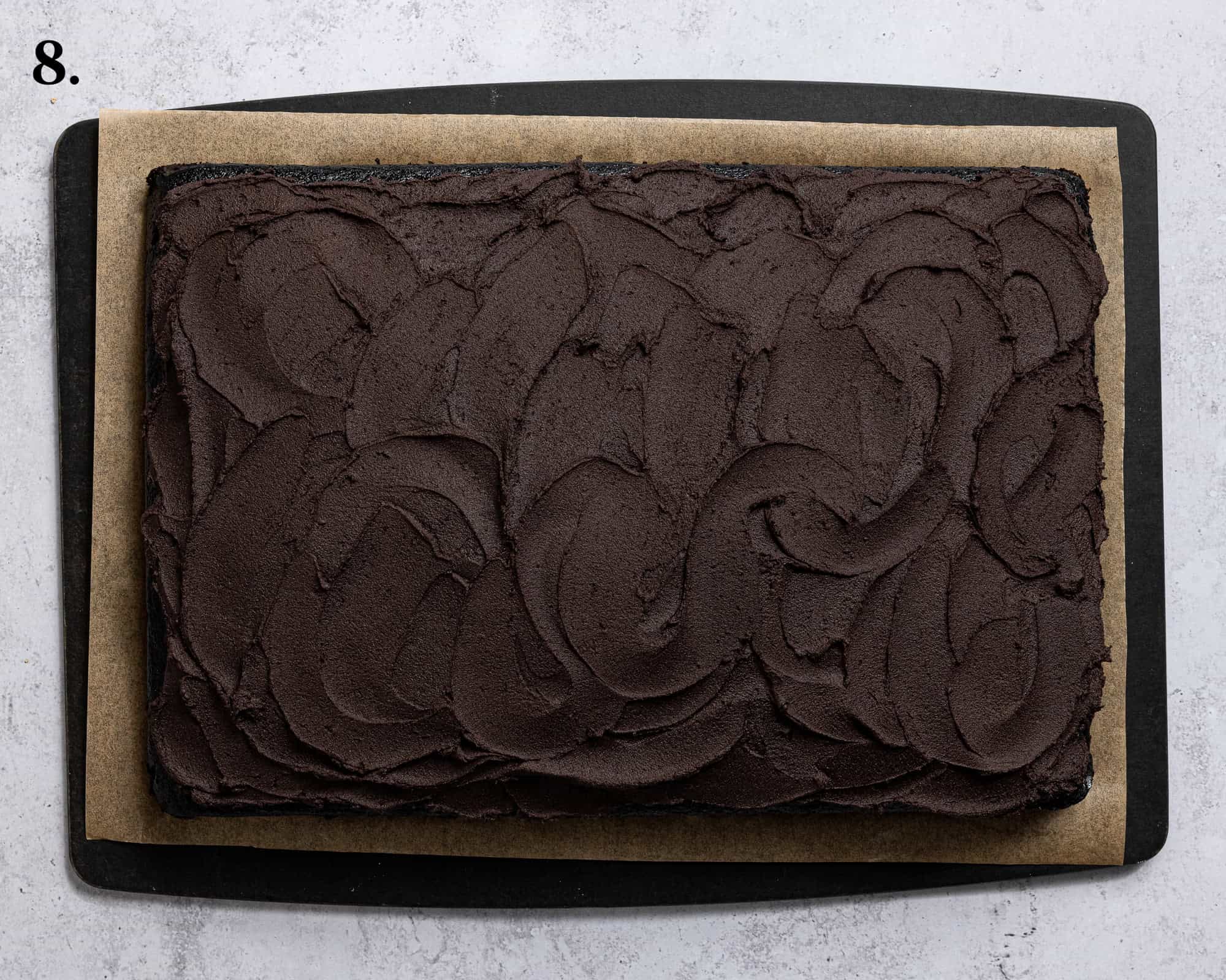 Step 8, the buttercream spread on top of the cake.